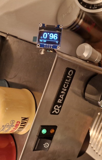 An image of an OLED display showing the current boiler temperature